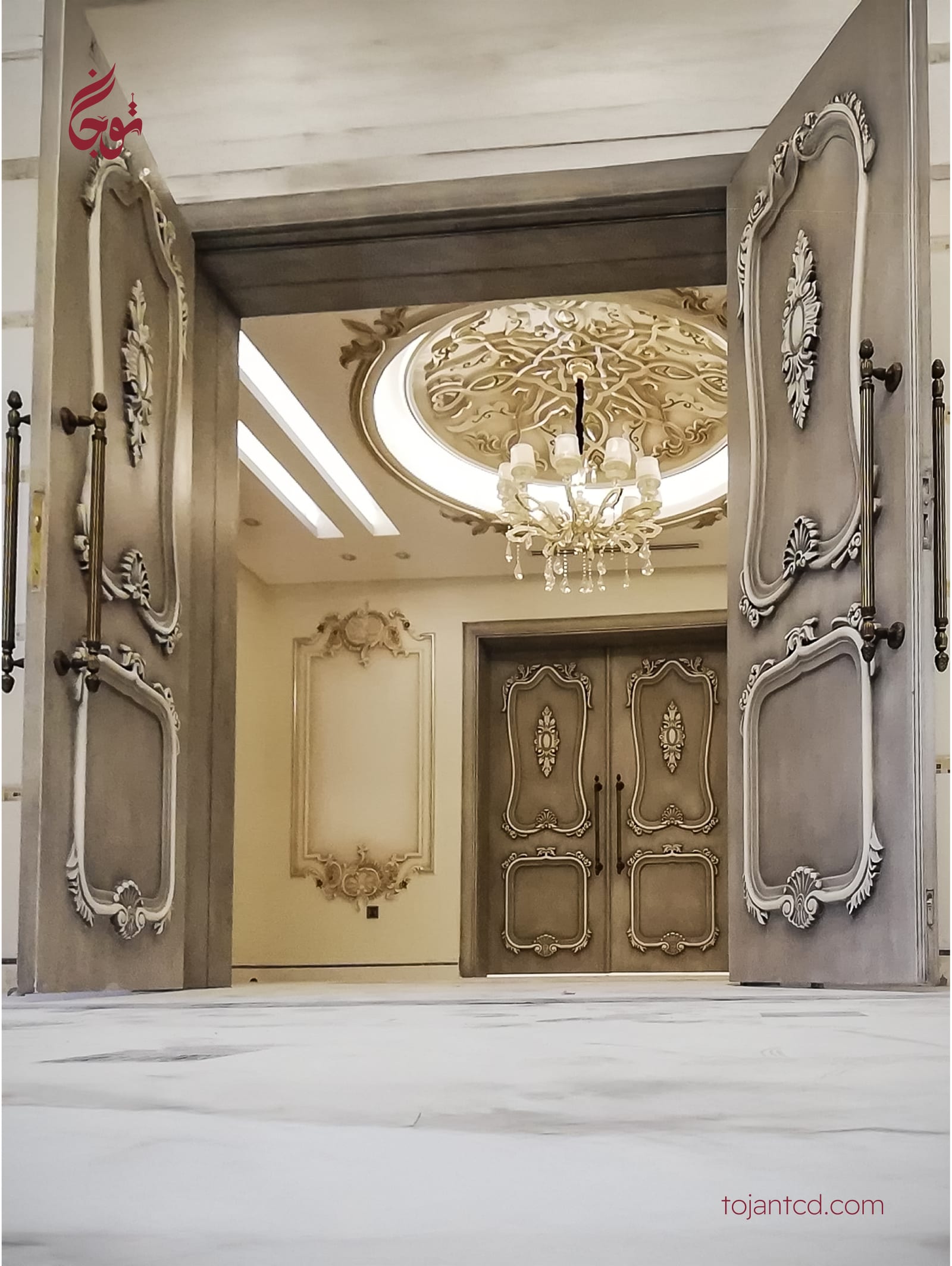 Grand carved double doors opening to a gold-leaf hall by Tojan TCD